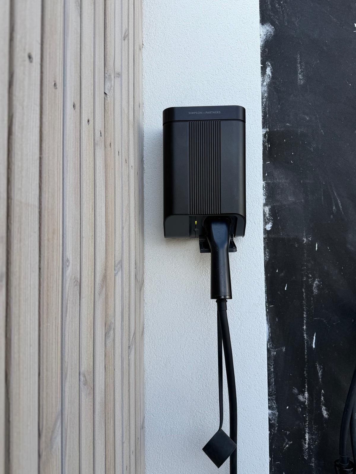 Simpson and Partners three-phase EV charger mounted on an exterior wall