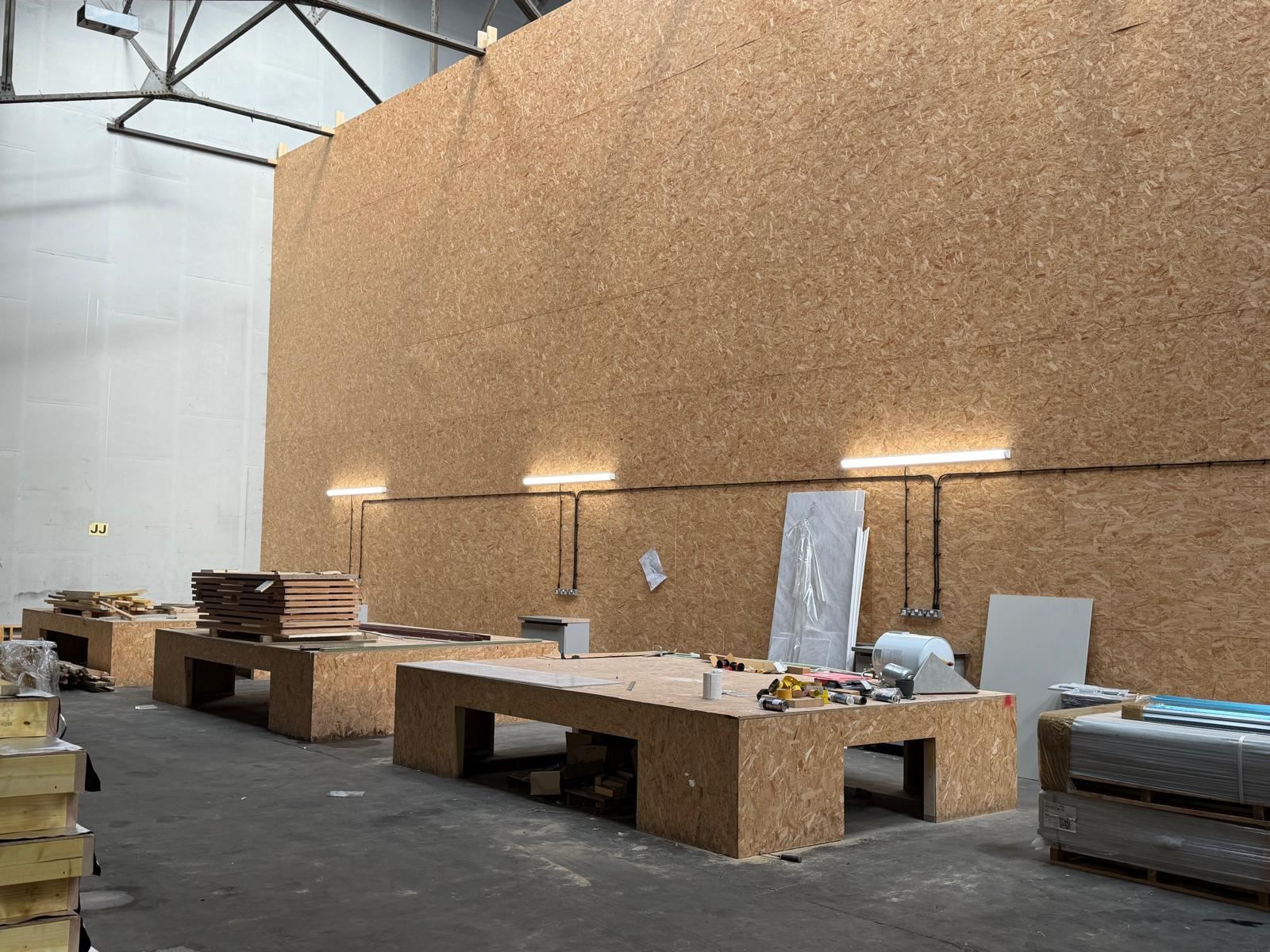 Row of industrial workbenches with LED bench lighting installed above