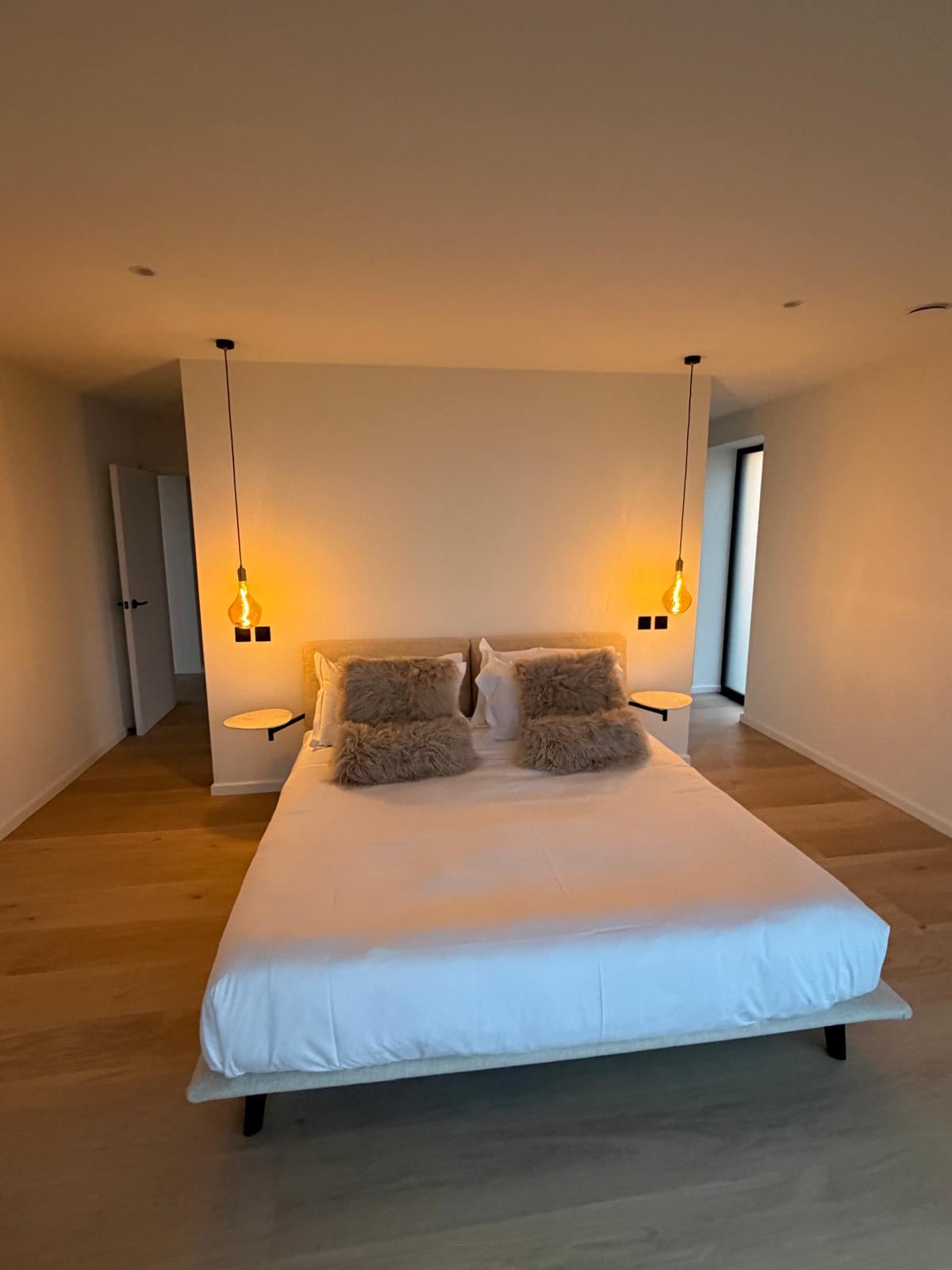Main bedroom with matching pendant lights either side of the bed