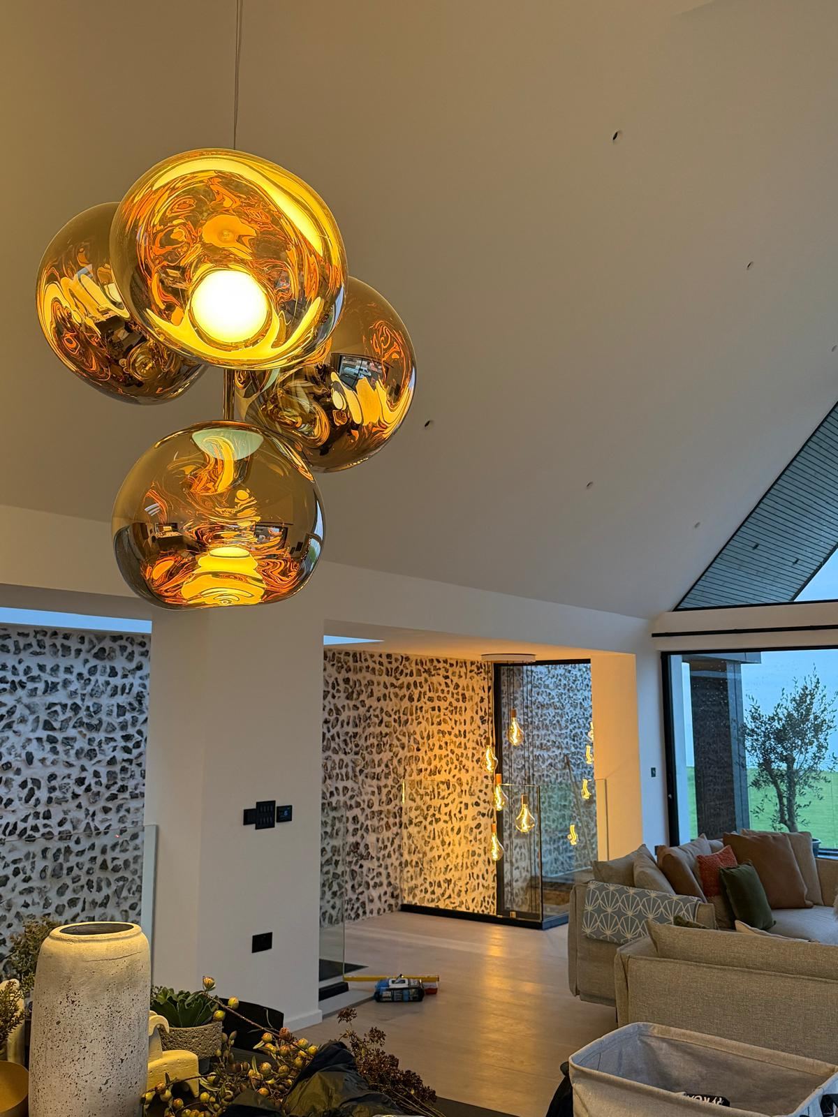 Bronze glass feature pendant light cluster installed in the open-plan living area